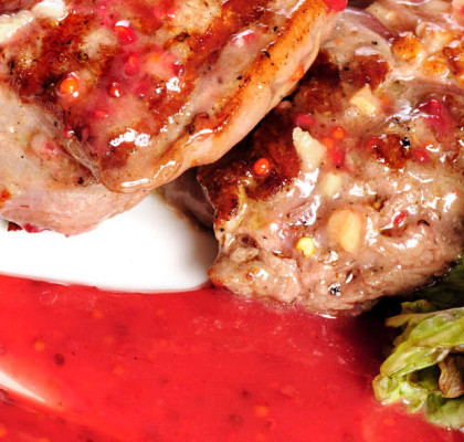 Grilled pork steaks with raspberry sauce and leaf of lettuce