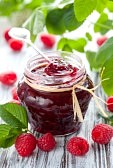 raspberry-jam-in-a-jar-and-fresh-berries-on-the-wooden-table